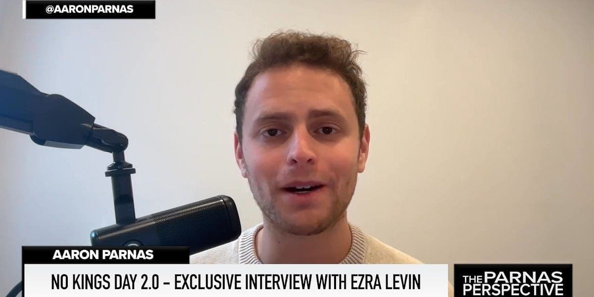 Protest signs and crowds during No Kings Day demonstration against expansion of presidential powers